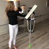 Yoga instructor spraying Clove Cinnamon Vanilla Cleaner on mop, safe and effective natural all-purpose cleaner.