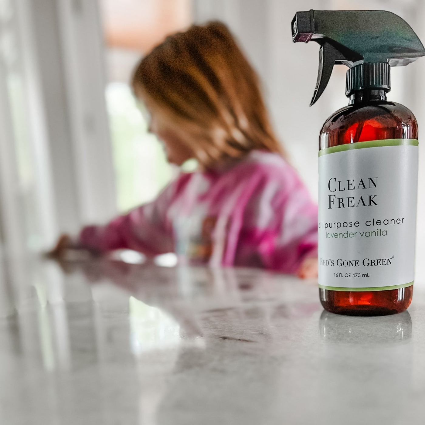 Lavender Vanilla All Purpose Cleaner bottle on granite countertop, safe and streak-free natural stone cleaner.