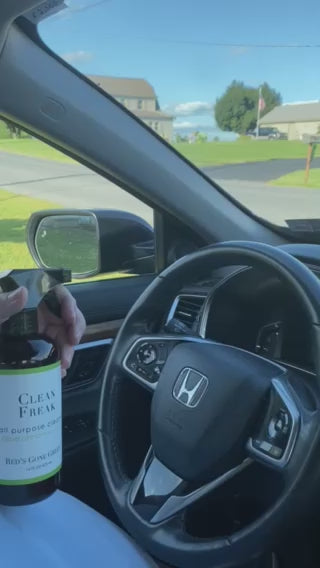 Woman spraying car steering wheel with Clove Cinnamon Vanilla safe ,natural cleaner for everyday use.