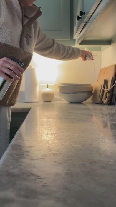 video of a mom spraying Clove Cinnamon Vanilla Cleaner on granite countertop, safe and effective natural all-purpose cleaner.