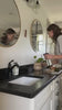 Video of mom spraying Peppermint Vanilla Cleaner on bathroom countertop and mirrors, safe and effective natural bathroom cleaner.