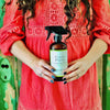 photo of lady holding a Red's Gone Green all natural cleaner
